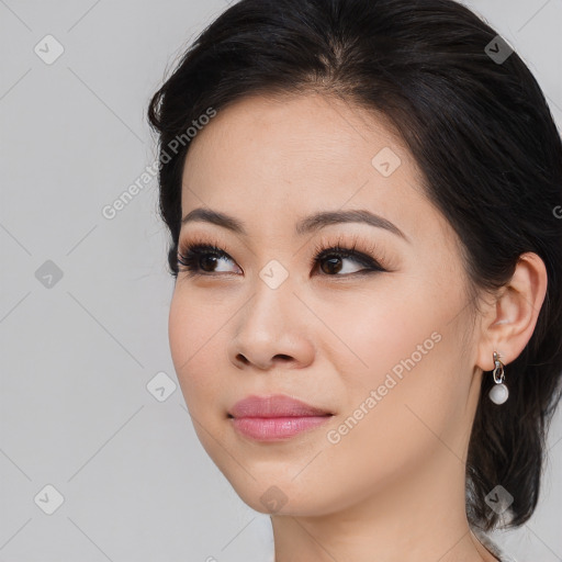 Joyful asian young-adult female with medium  brown hair and brown eyes