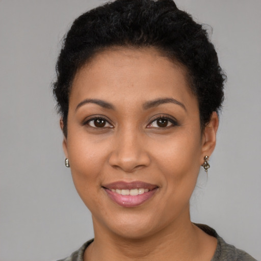 Joyful latino young-adult female with short  brown hair and brown eyes