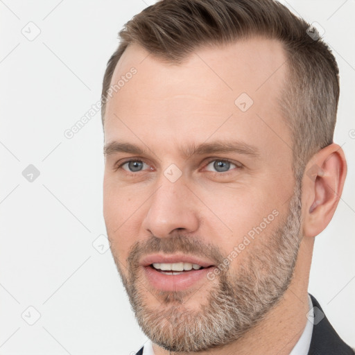 Joyful white adult male with short  brown hair and grey eyes