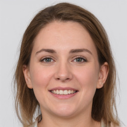 Joyful white young-adult female with medium  brown hair and grey eyes