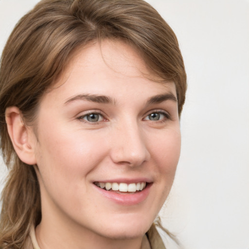 Joyful white young-adult female with long  brown hair and grey eyes