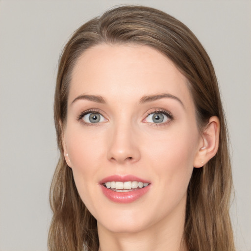 Joyful white young-adult female with long  brown hair and blue eyes