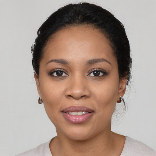 Joyful latino young-adult female with short  black hair and brown eyes