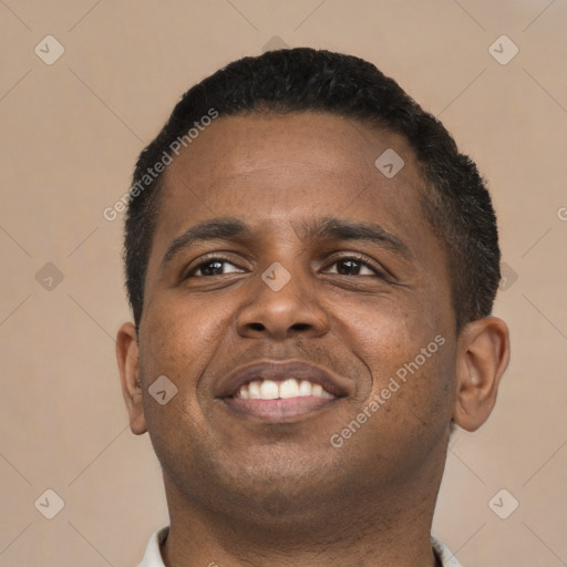 Joyful black young-adult male with short  brown hair and brown eyes