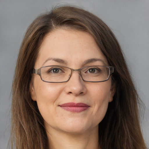 Joyful white adult female with long  brown hair and grey eyes