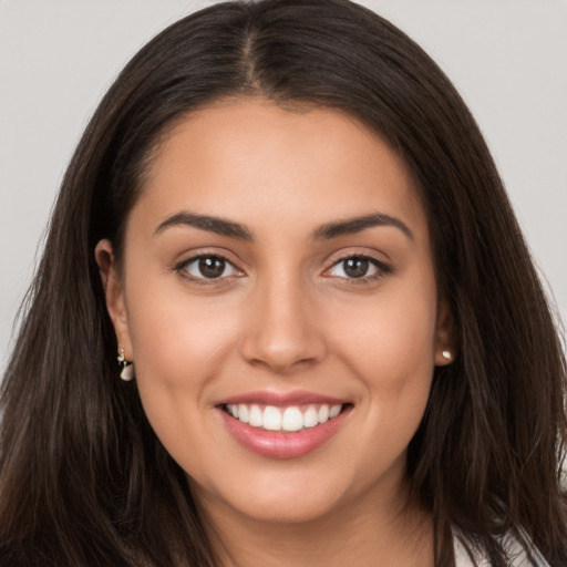 Joyful white young-adult female with long  brown hair and brown eyes