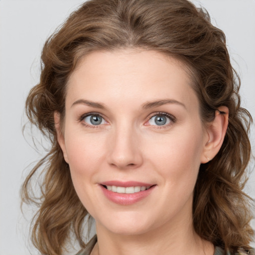 Joyful white young-adult female with medium  brown hair and blue eyes