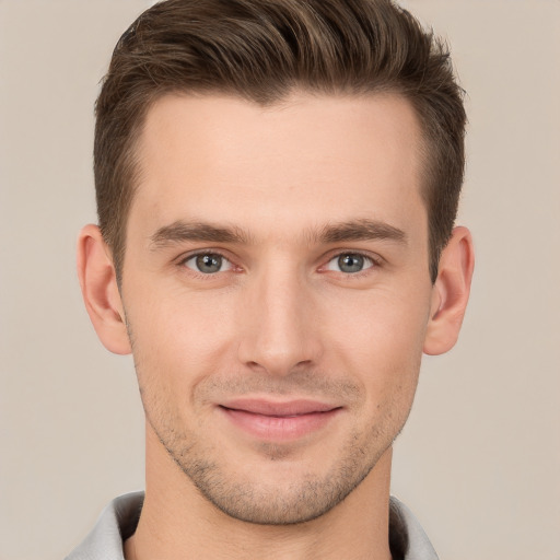 Joyful white young-adult male with short  brown hair and brown eyes