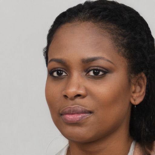 Joyful black young-adult female with short  brown hair and brown eyes