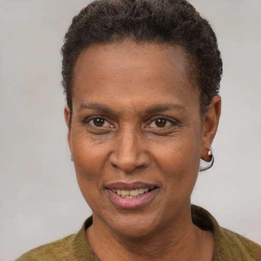 Joyful black adult female with short  brown hair and brown eyes