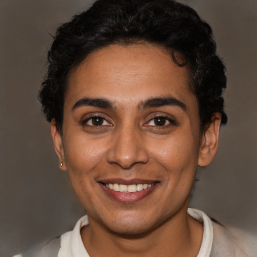 Joyful latino young-adult female with short  brown hair and brown eyes