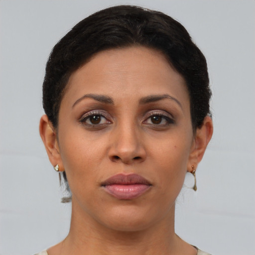 Joyful latino young-adult female with short  brown hair and brown eyes