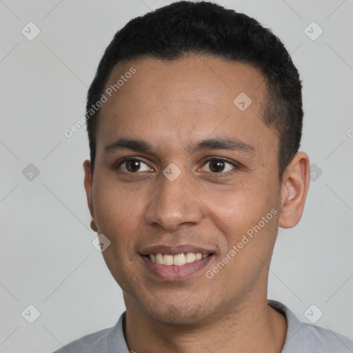 Joyful latino young-adult male with short  black hair and brown eyes