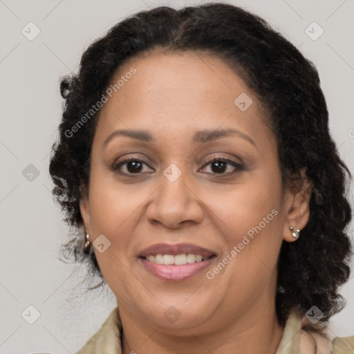 Joyful black adult female with long  brown hair and brown eyes