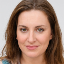 Joyful white young-adult female with long  brown hair and green eyes