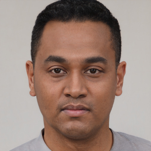 Neutral latino young-adult male with short  black hair and brown eyes