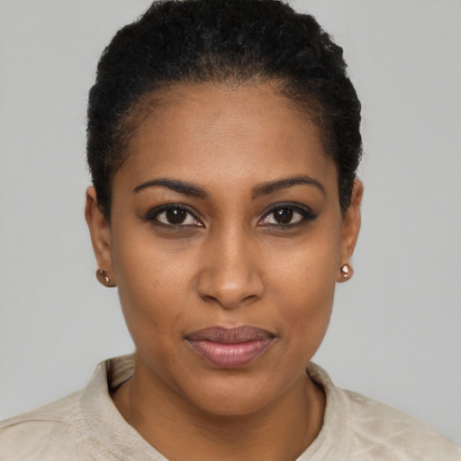Joyful black young-adult female with short  brown hair and brown eyes