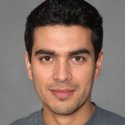 Joyful white young-adult male with short  black hair and brown eyes