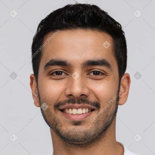 Joyful latino young-adult male with short  black hair and brown eyes