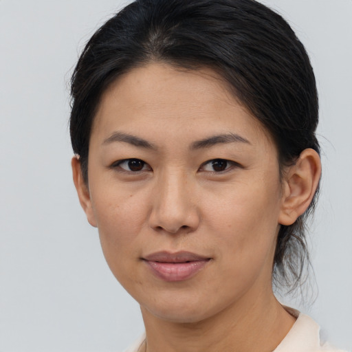 Joyful asian young-adult female with medium  brown hair and brown eyes
