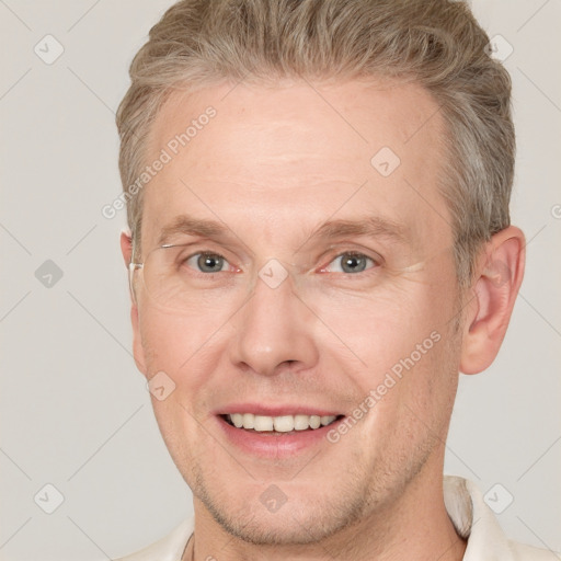 Joyful white adult male with short  brown hair and grey eyes