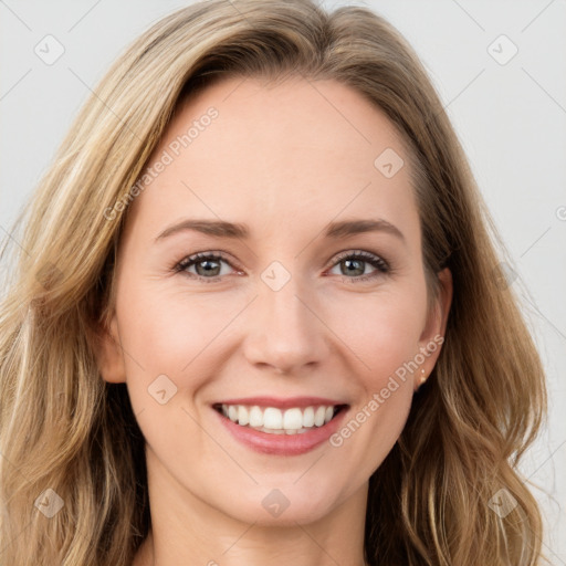 Joyful white young-adult female with long  brown hair and green eyes