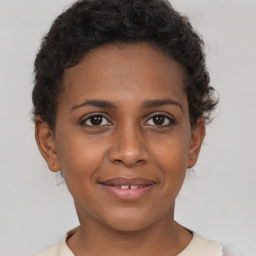 Joyful black young-adult female with short  brown hair and brown eyes