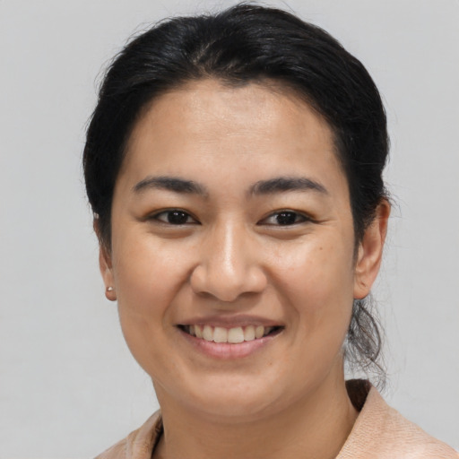 Joyful asian young-adult female with short  brown hair and brown eyes
