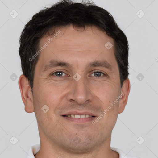 Joyful white adult male with short  brown hair and brown eyes