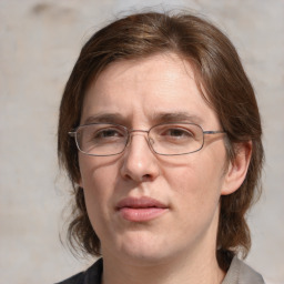 Joyful white adult female with medium  brown hair and grey eyes