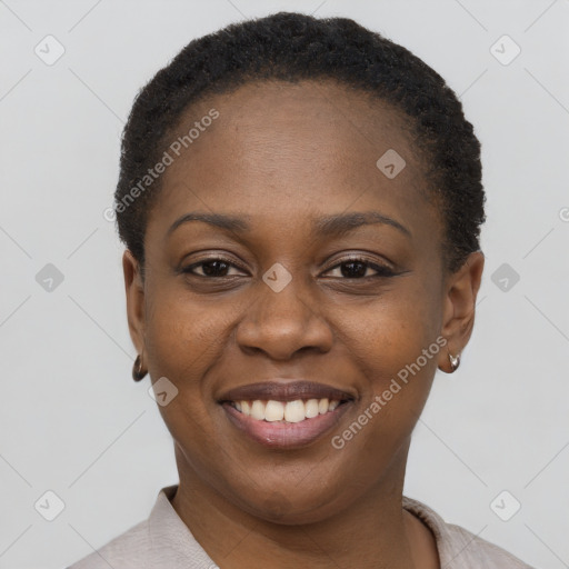 Joyful black young-adult female with short  brown hair and brown eyes