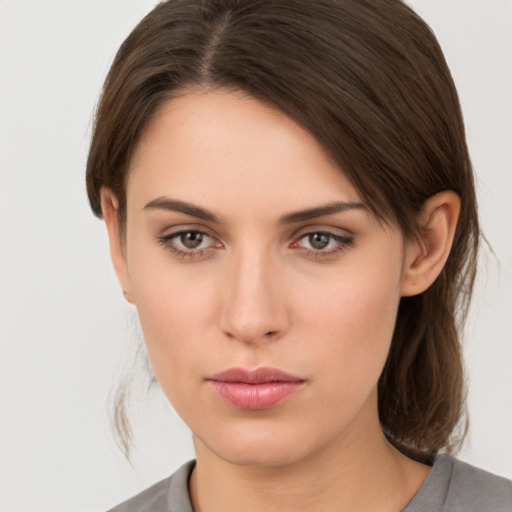 Neutral white young-adult female with medium  brown hair and brown eyes