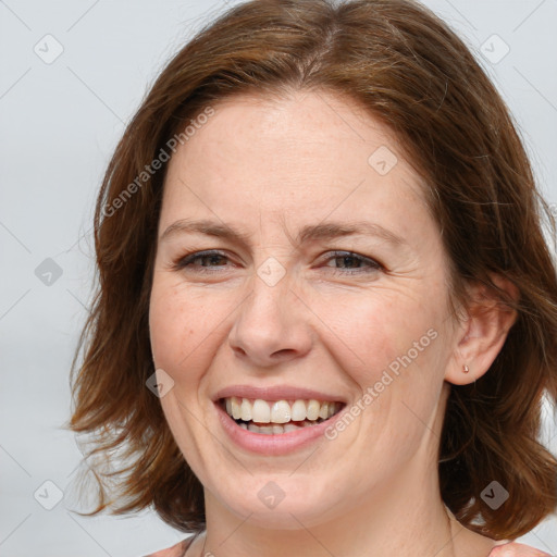 Joyful white adult female with medium  brown hair and blue eyes