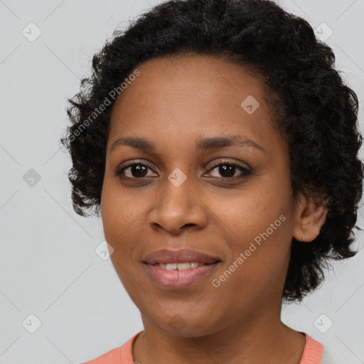 Joyful black young-adult female with long  brown hair and brown eyes