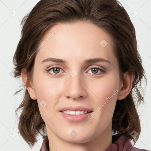 Joyful white young-adult female with medium  brown hair and green eyes