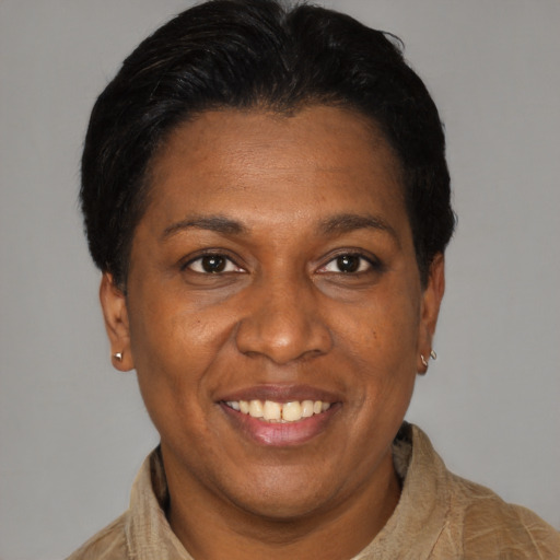 Joyful latino adult female with short  black hair and brown eyes