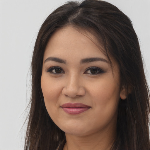 Joyful latino young-adult female with long  brown hair and brown eyes