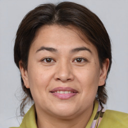 Joyful white adult female with medium  brown hair and brown eyes