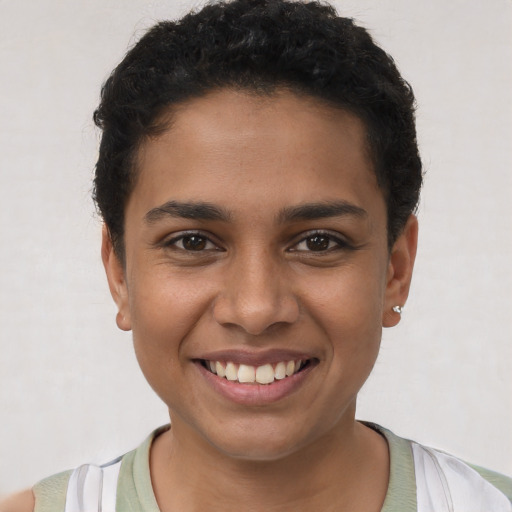 Joyful latino young-adult female with short  brown hair and brown eyes