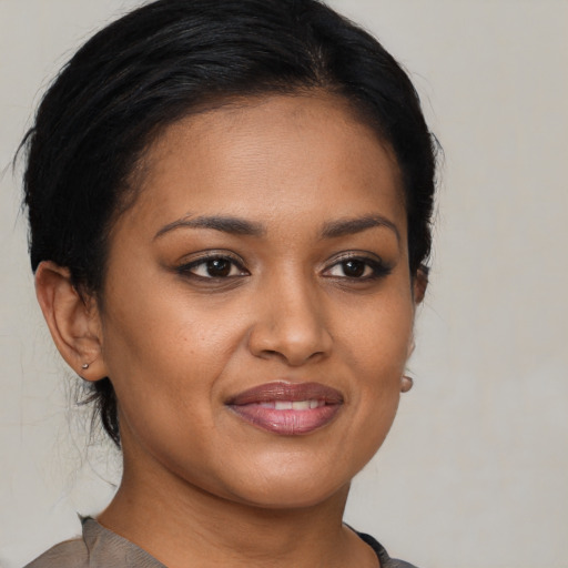 Joyful black young-adult female with medium  brown hair and brown eyes