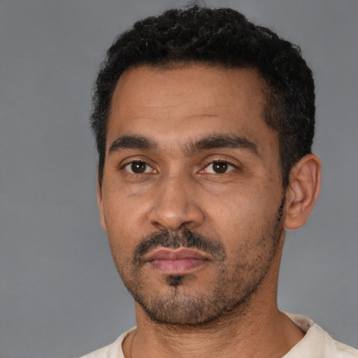 Neutral latino adult male with short  black hair and brown eyes