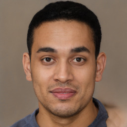 Joyful latino young-adult male with short  brown hair and brown eyes