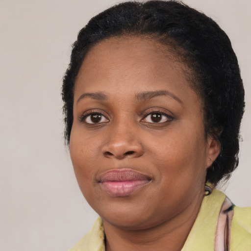 Joyful black young-adult female with medium  brown hair and brown eyes