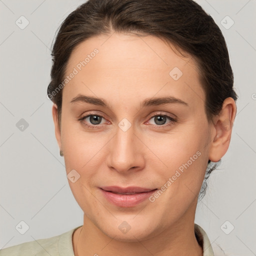 Joyful white young-adult female with medium  brown hair and brown eyes