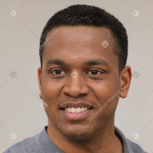 Joyful black young-adult male with short  black hair and brown eyes