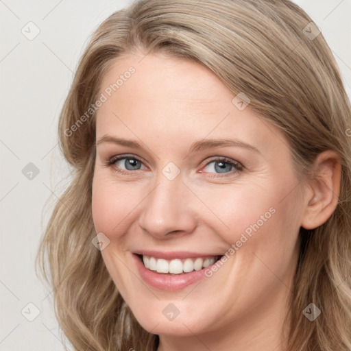 Joyful white young-adult female with long  brown hair and blue eyes