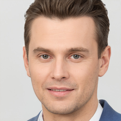 Joyful white young-adult male with short  brown hair and brown eyes