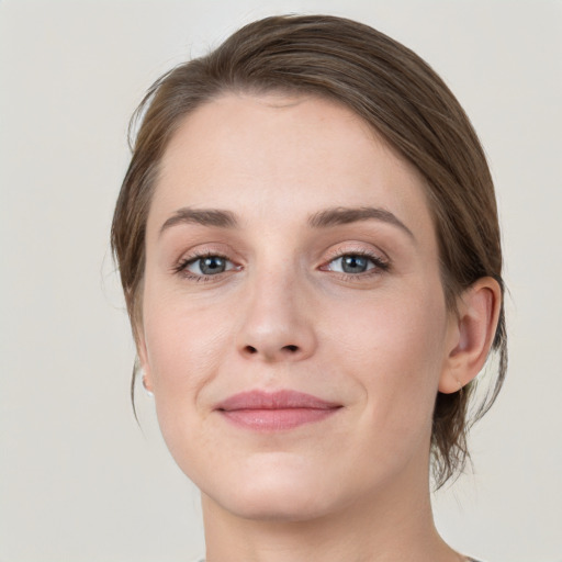 Joyful white young-adult female with medium  brown hair and grey eyes