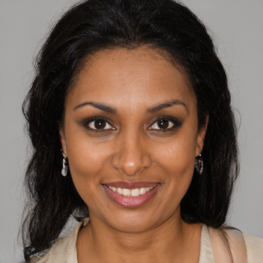 Joyful black young-adult female with medium  brown hair and brown eyes