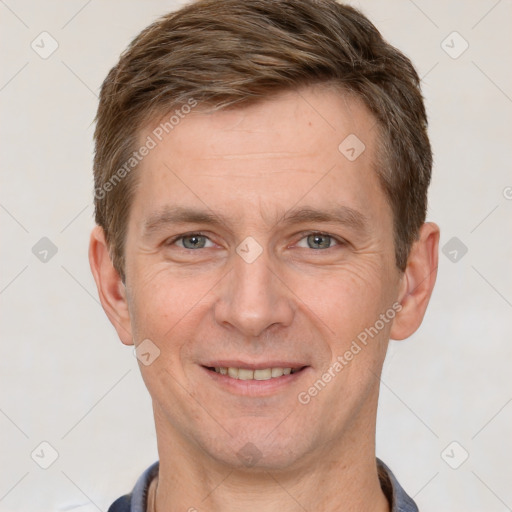 Joyful white adult male with short  brown hair and grey eyes